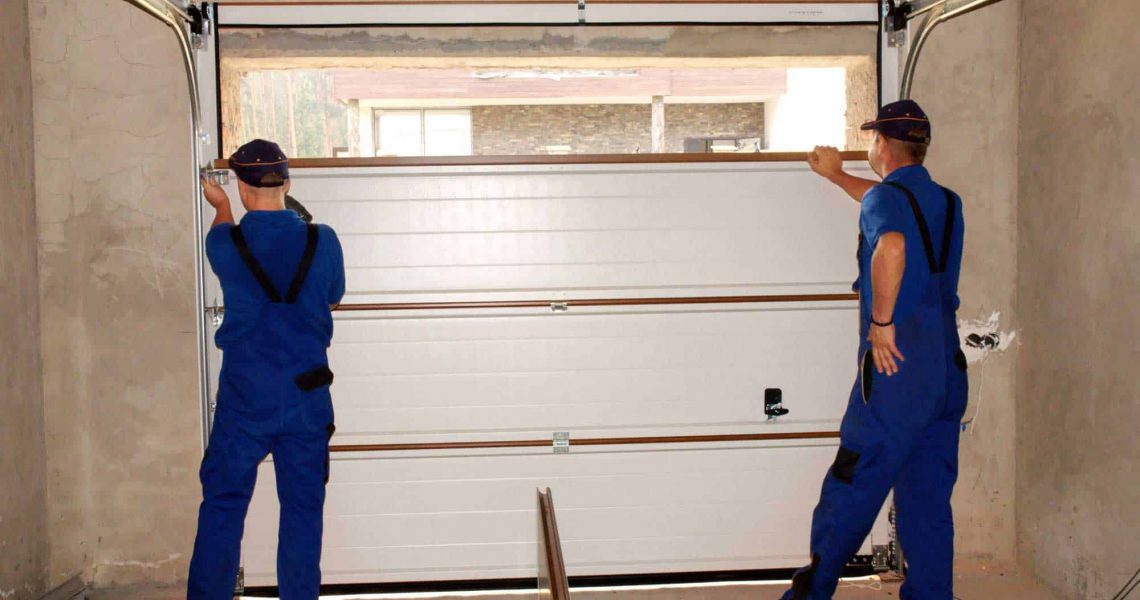 2 men installing garage door