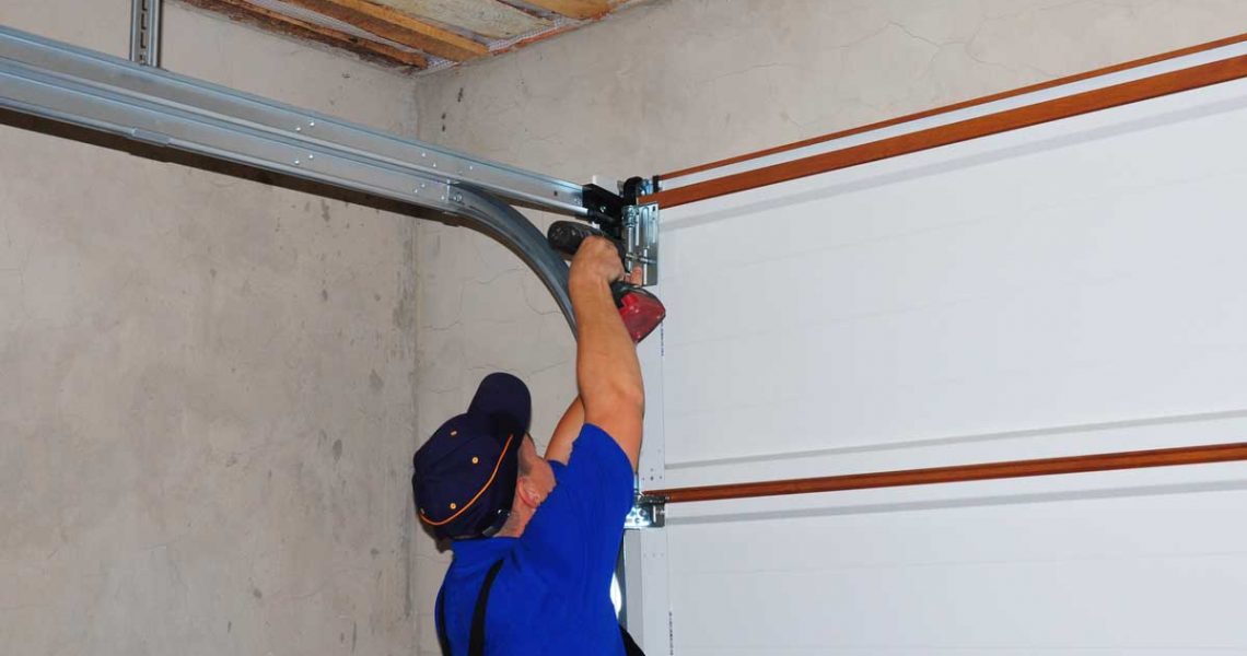 person repairing inside garage door